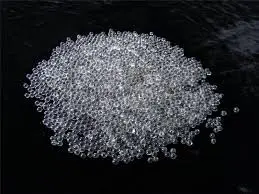 "Close-up of GB-3 Coarse II BL glass bead abrasive particles, 425-600 micron size, showing clear spherical shape."