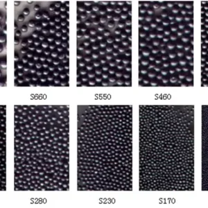 Coreblast Solutions high carbon cast steel shots in a clear display jar showing spherical shape and premium quality metallic blast media